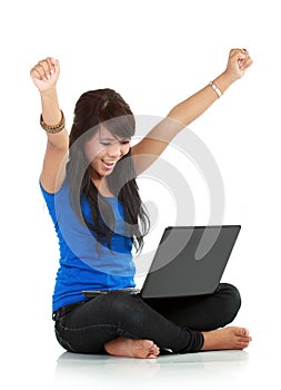 Happy and lucky young woman with laptop