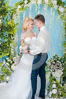 Happy luxury bride and groom in interior studio