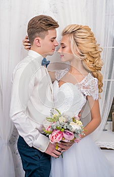 Happy luxury bride and groom in interior studio