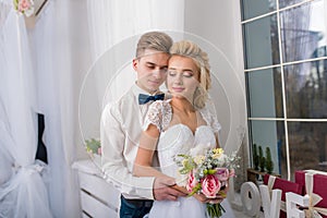 happy luxury bride and groom in interior studio