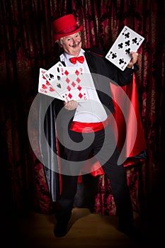 Happy magician with cards