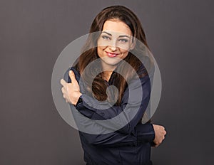 Happy makeup business woman hugging herself with natural emotional natural makeup face. Closeup