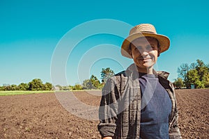 Happy male agro tourist in hat. Authentic rural farmer portrait. Agriculture worker. Vegetable garden. Rustic background. Country