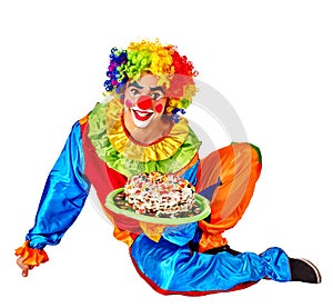 Happy male birthday clown holding cake.