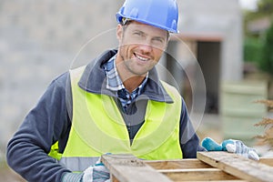 happy male builder looking at camera
