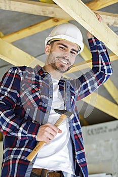 Happy male carpenter with hammer