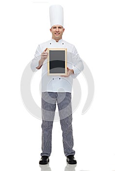 Happy male chef cook holding blank menu board