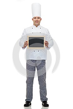 Happy male chef cook holding blank menu board