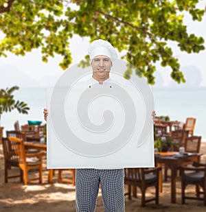 Happy male chef cook holding white blank big board