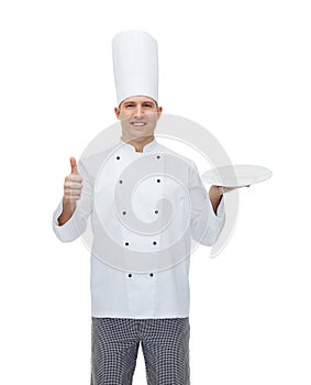 Happy male chef cook showing thumbs up and plate