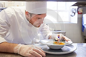 Happy male chef cooking food at restaurant kitchen