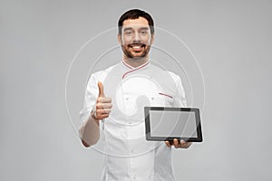 happy male chef with tablet pc showing thumbs up