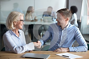 Happy male client employee handshake broker hr manager at meeting