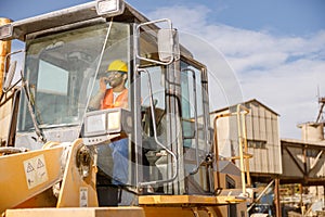 Manual worker driving cargo truck in plant