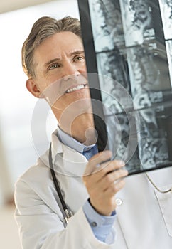 Happy Male Doctor Analyzing X-Ray Image