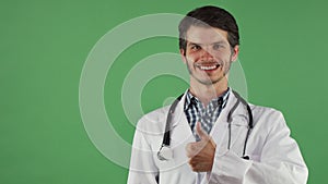 Happy male doctor showing thumbs up smiling cheerfully