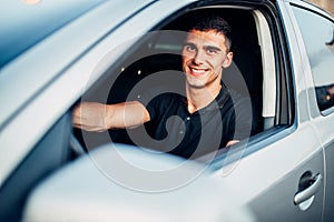 Happy male driver in car, advertising concept