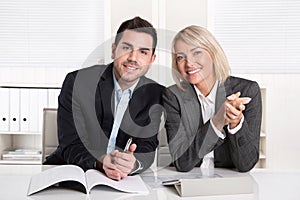 Happy male and female business team sitting in the office. Successful collaboration or partnership,