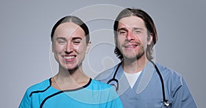 Happy male and female medical professionals over white background