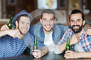 Happy male friends drinking beer at bar or pub