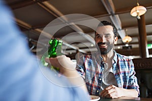 Happy male friends drinking beer at bar or pub