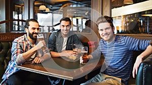 Happy male friends drinking beer at bar or pub