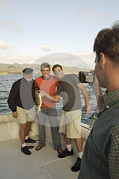 Happy Male Friends Enjoying Fishing