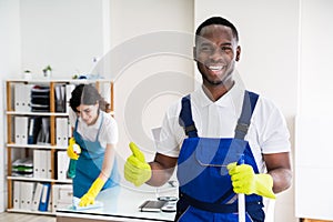 Happy Male Janitor In Office photo