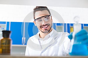 Happy male laboratorian placing bulb