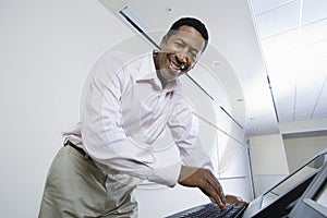 Happy Male Lecturer Using Computer