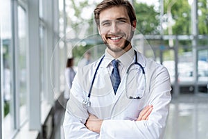 Happy male medical doctor portrait in hospital.