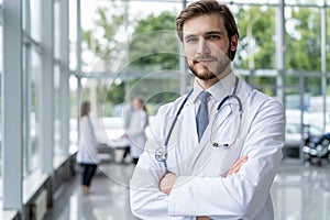 Happy male medical doctor portrait in hospital.