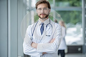 Happy male medical doctor portrait in hospital.