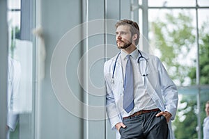 Happy male medical doctor portrait in hospital.