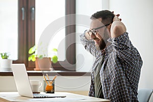 Happy male stretching satisfied with good news