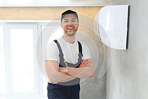 Happy Male Technician Repairing Air Conditioner.