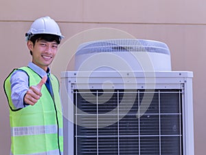 Happy Male Technician Repairing Air Conditioner With Screwdriver