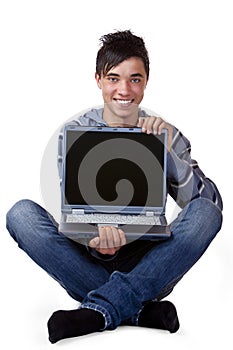 Happy male teenager holding laptop computer