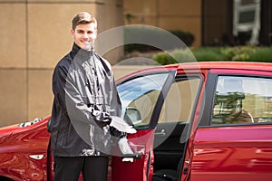 Happy Male Valet Opening Car Door