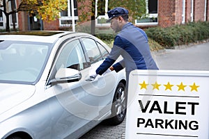 Happy Male Valet Opening Car Door