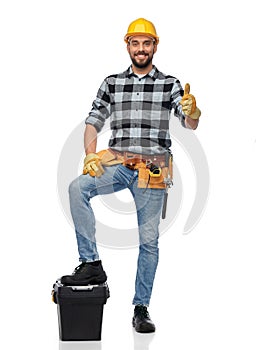 Happy male worker or builder showing thumbs up