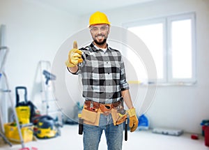Happy male worker or builder showing thumbs up photo