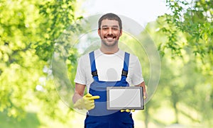 happy male worker or cleaner showing tablet pc