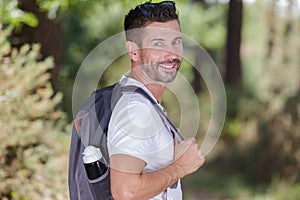 happy man in 40s hiking mountain peak