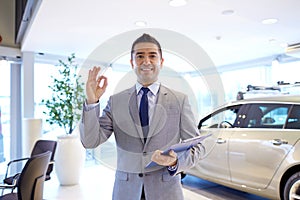 Happy man at auto show or car salon