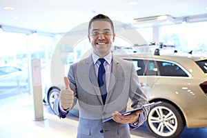 Happy man at auto show or car salon