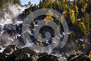 Happy man with backpack enjoying amazing waterfall Travel Lifestyle and success concept vacations into the wild nature