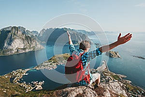 Happy Man backpacker raised hands traveling