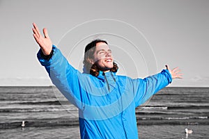 Happy man on the beach - b&w background. Overcoming depression