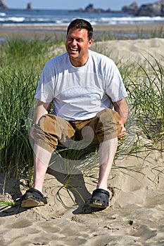 Happy man at beach white legs